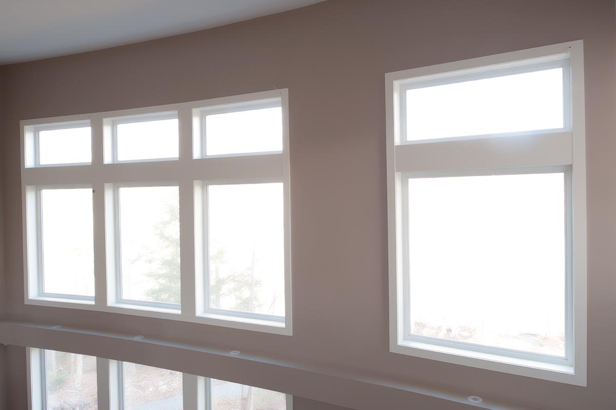 large picture windows above large awning windows