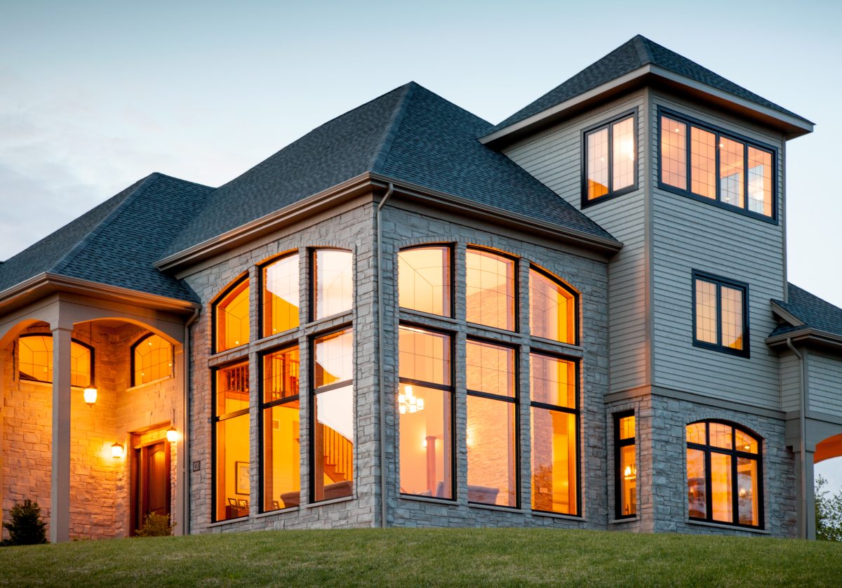 large beautiful home with three stories of large expansive windows