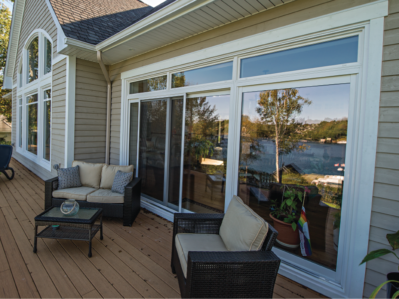 exterior view of patio doors and large windows with transoms
