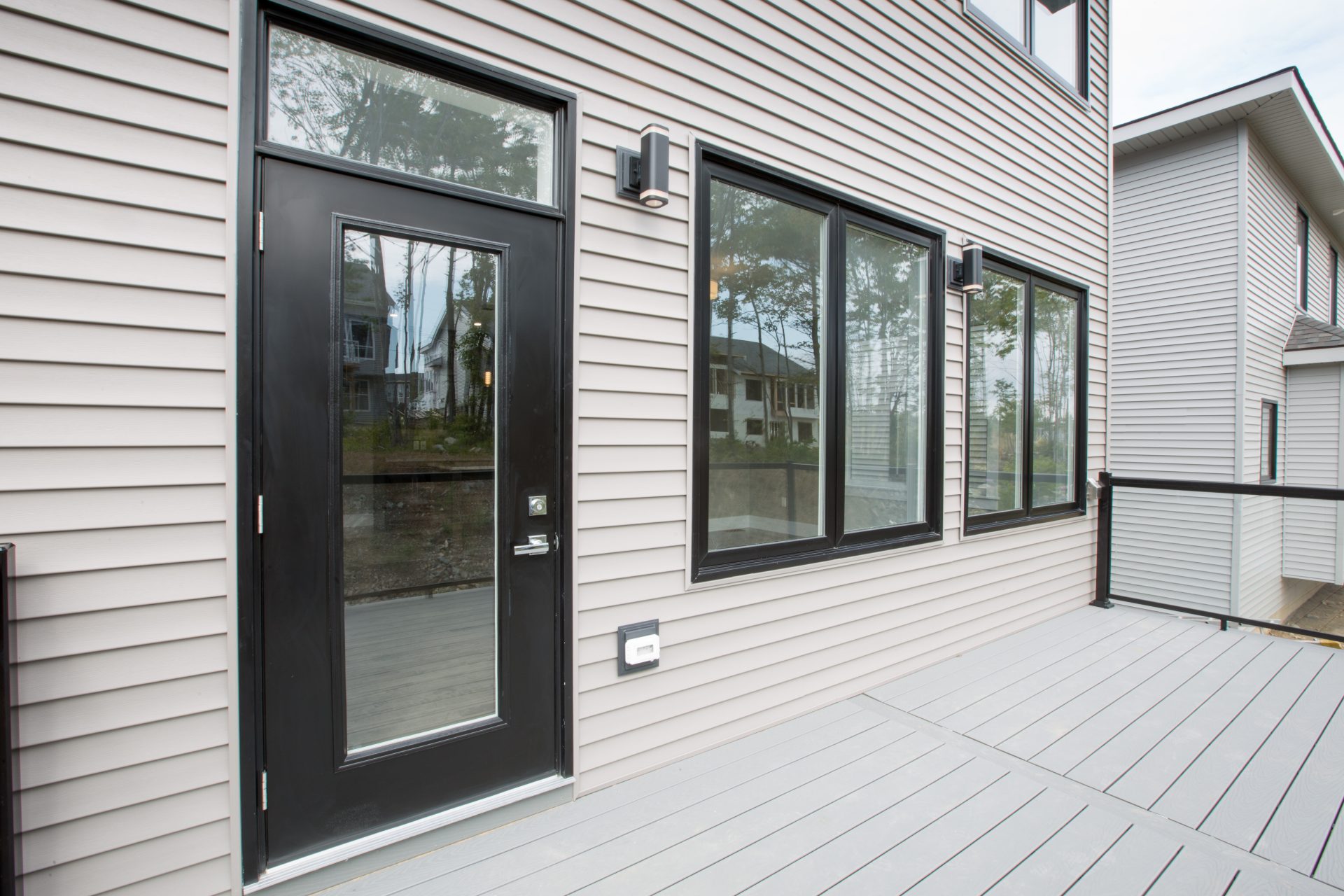 exterior painted black single entrance door and two sets of casement windows