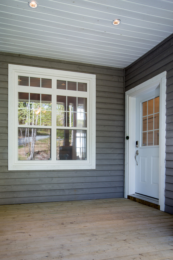 exterior view of two single hung windows and single entrance door