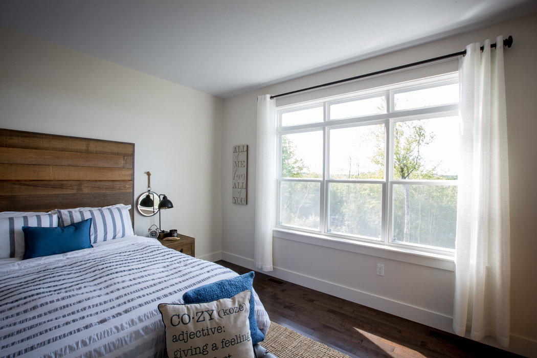 interior view of bedroom with three single hung windows