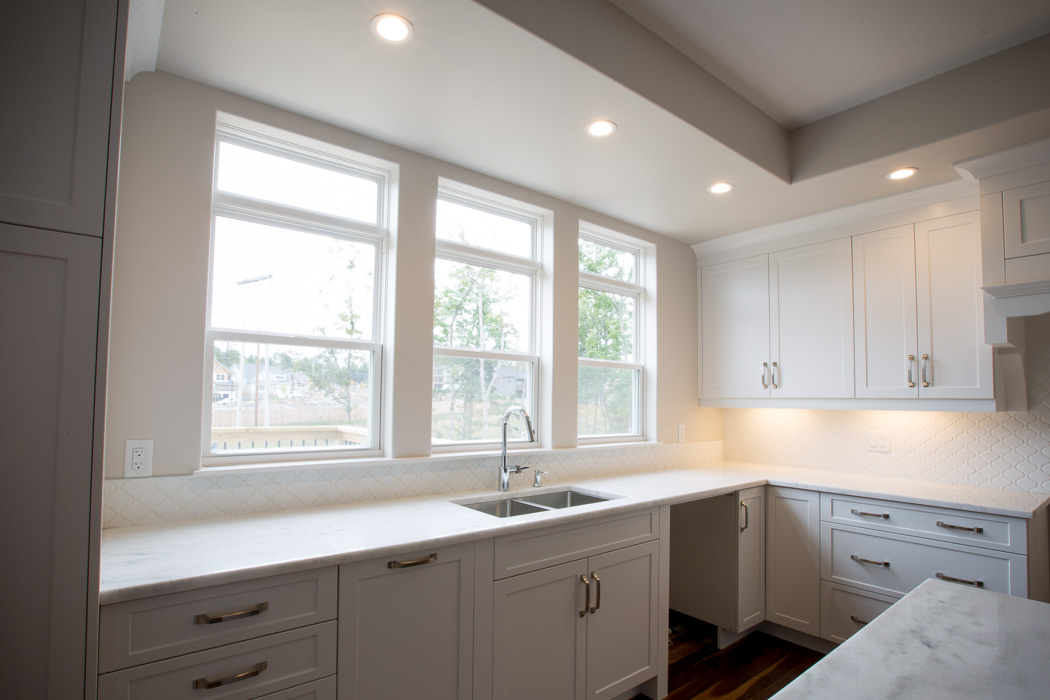 Interior view of three double hung windows in a kitchen